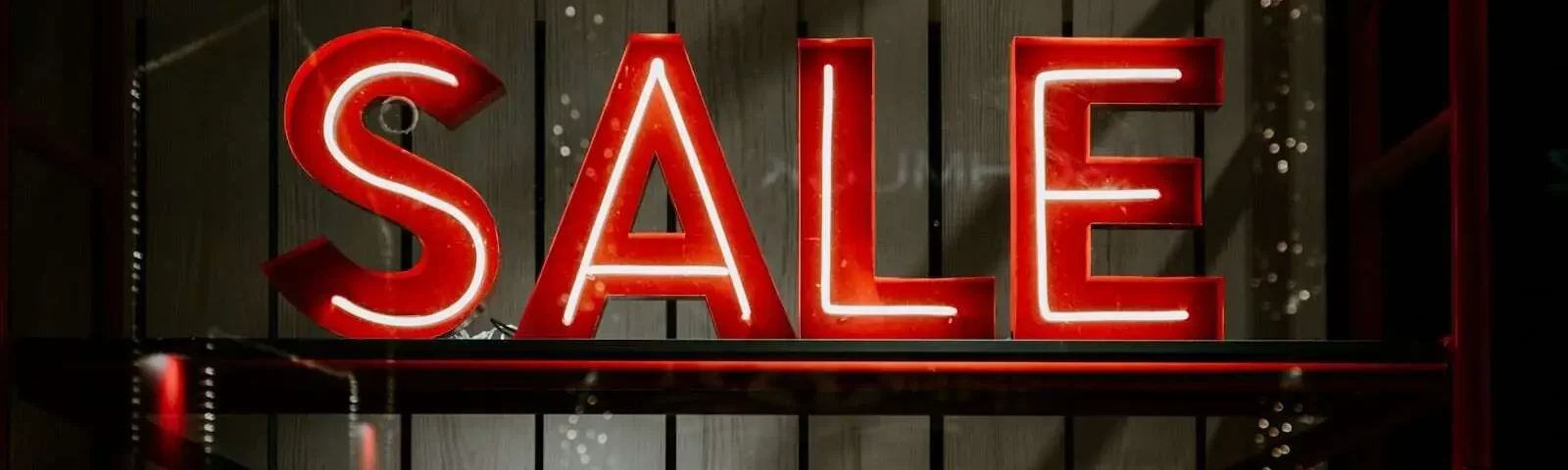 Photo by Claudio Schwarz red and white sale LED sign